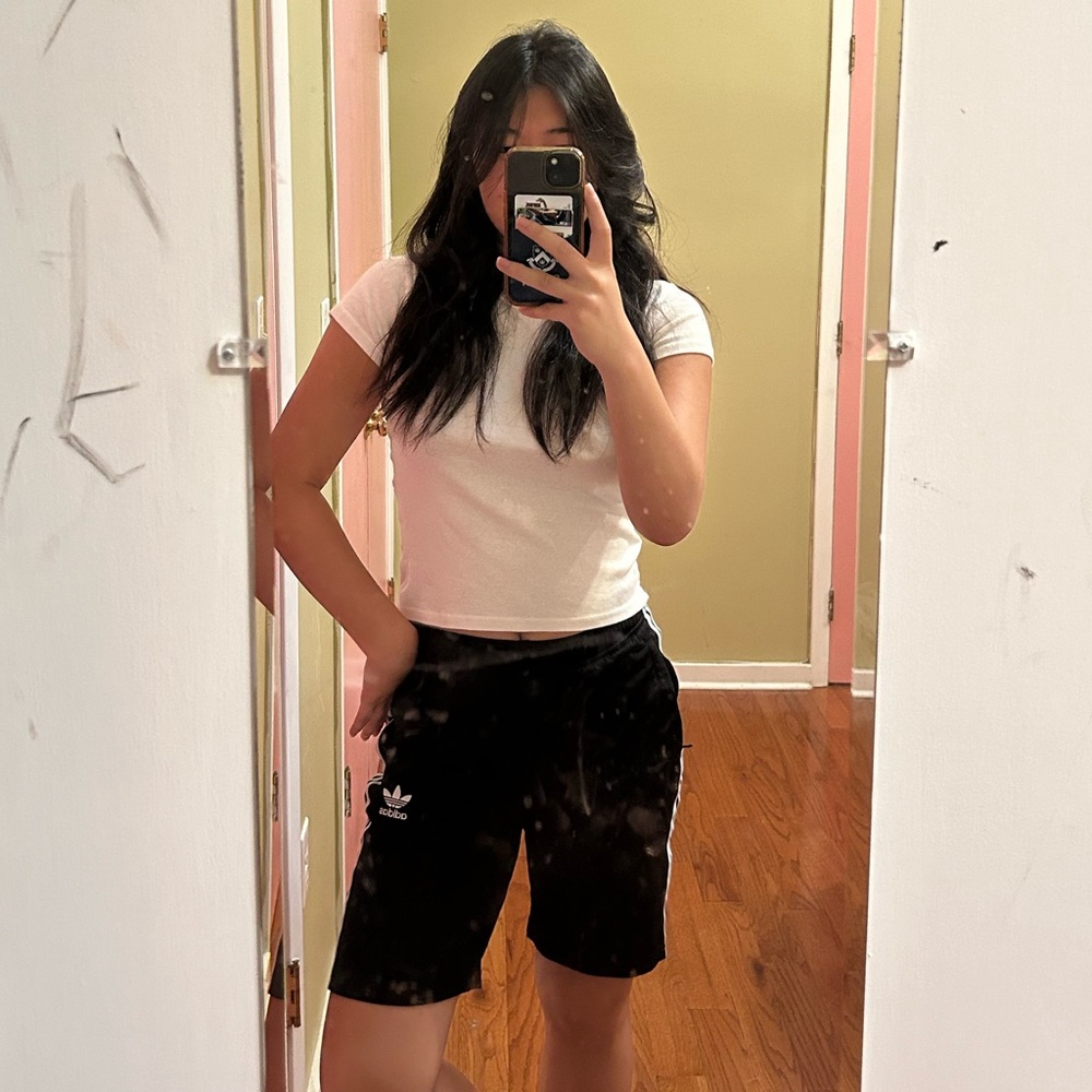 Long Adidas classic black and white-striped shorts.